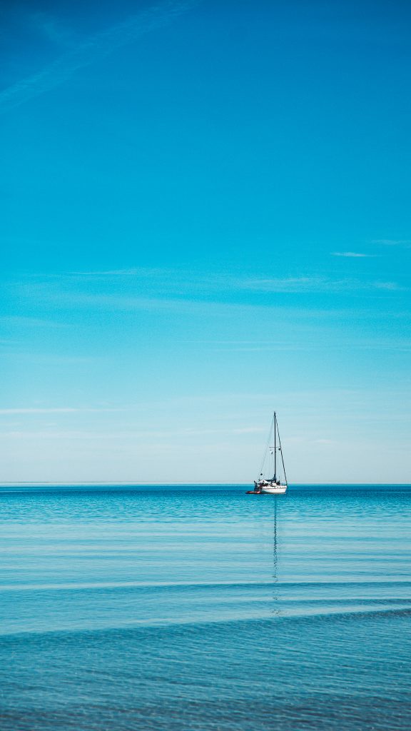 Einzelnes Segelboot auf ruhiger Ostsee vor Scharbeutz